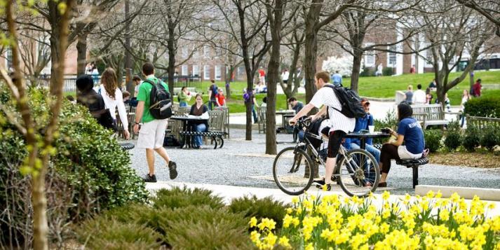Students walking and ridding bike outside UMD campus