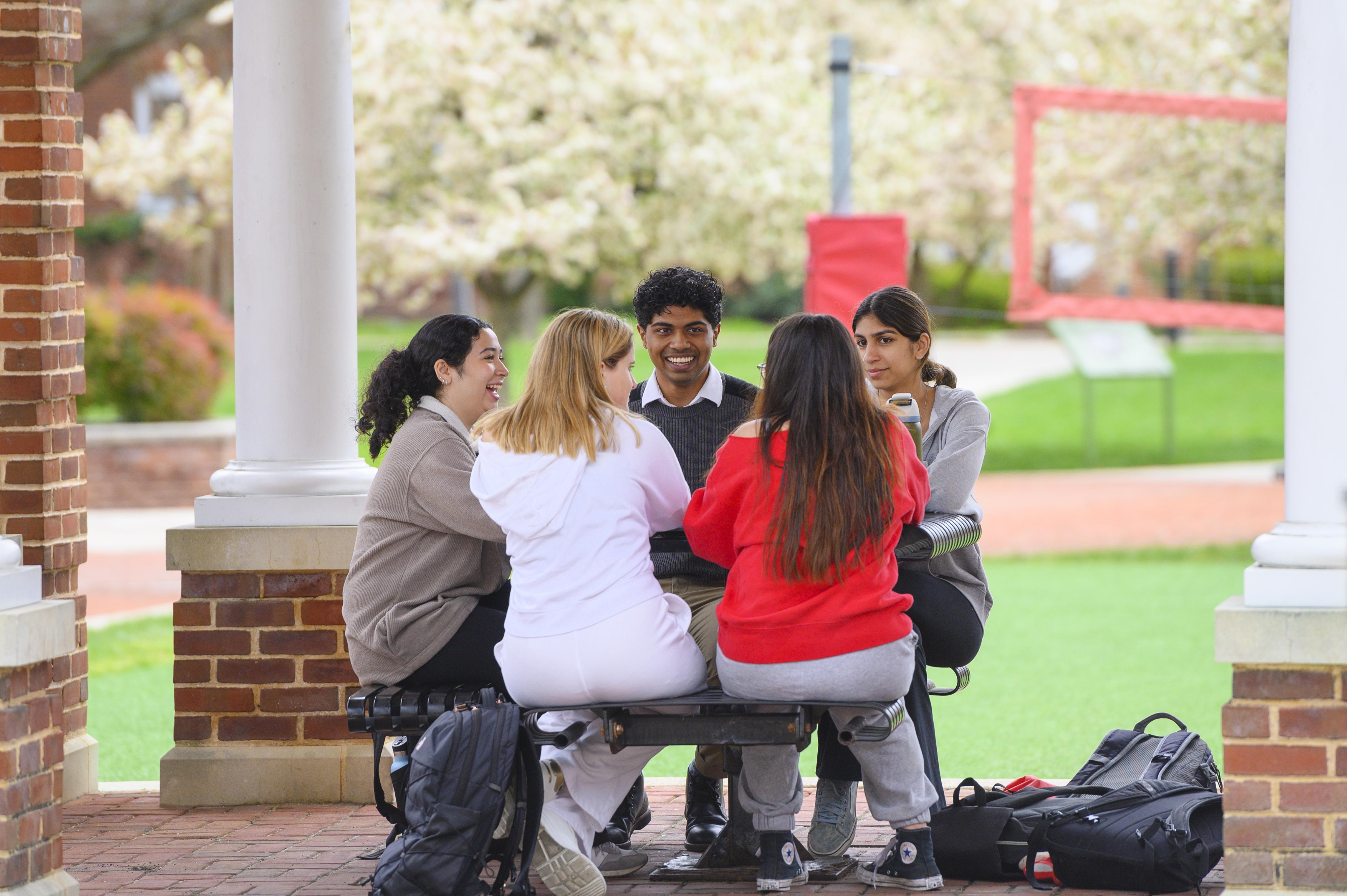 Students chatting at table outside