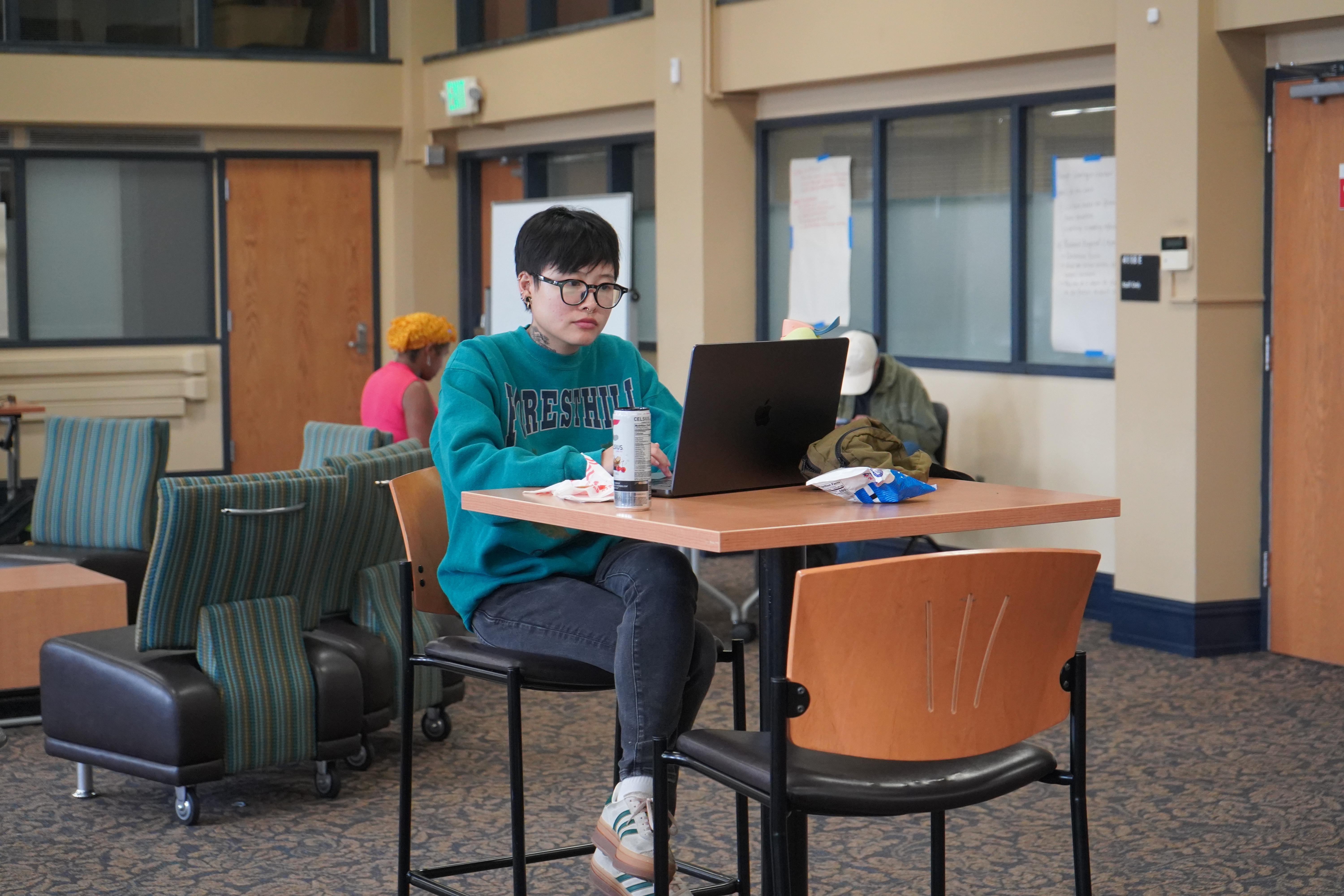 Graduate Student typing on laptop at Writing Retreat