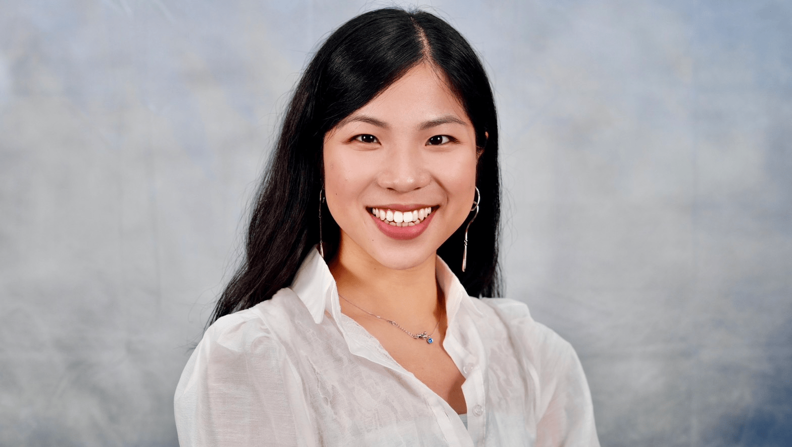 Writing Fellow Chia-Shuan Chang smiling into the camera.