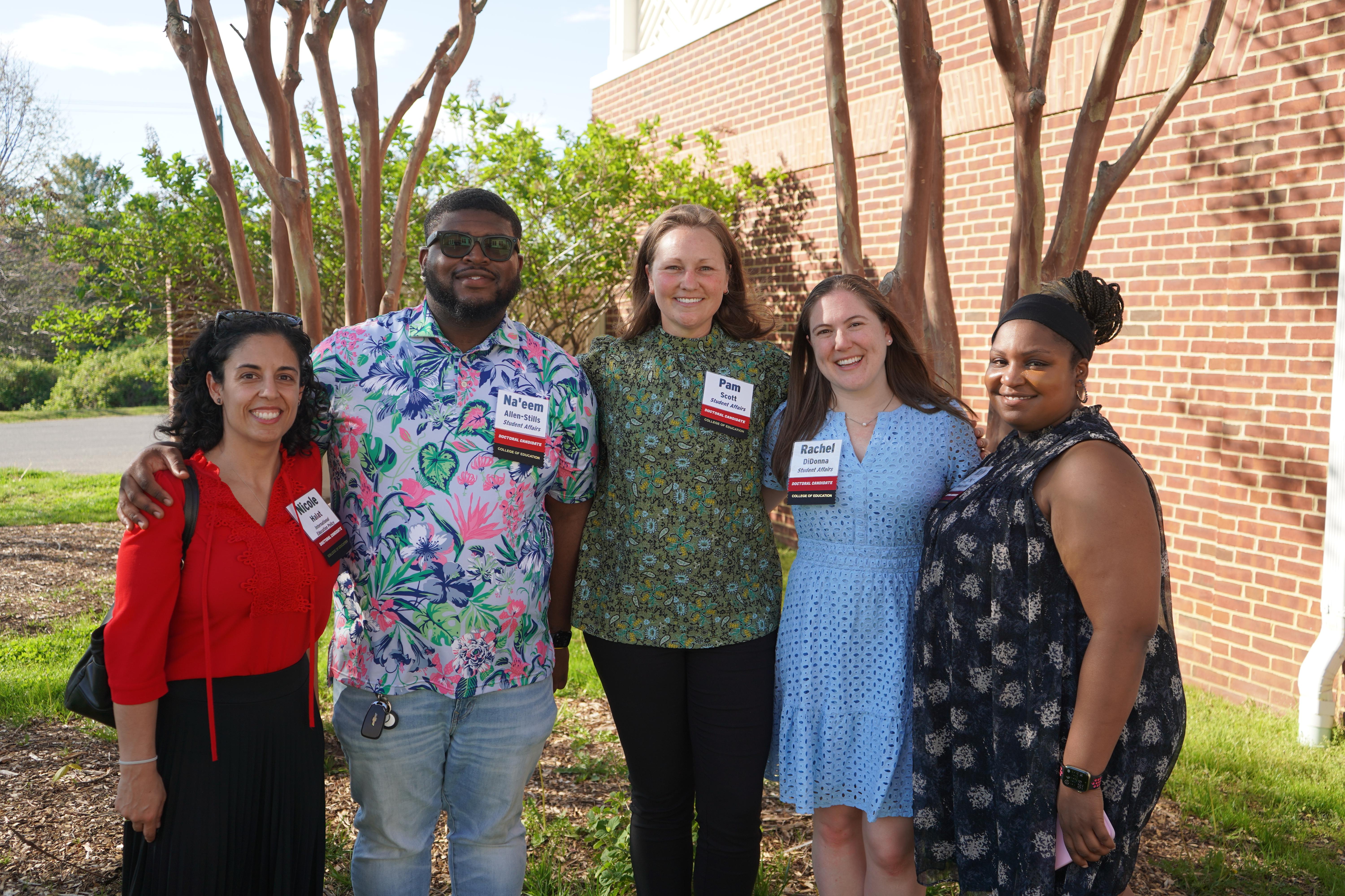Five Doctoral Candidates at a celebration