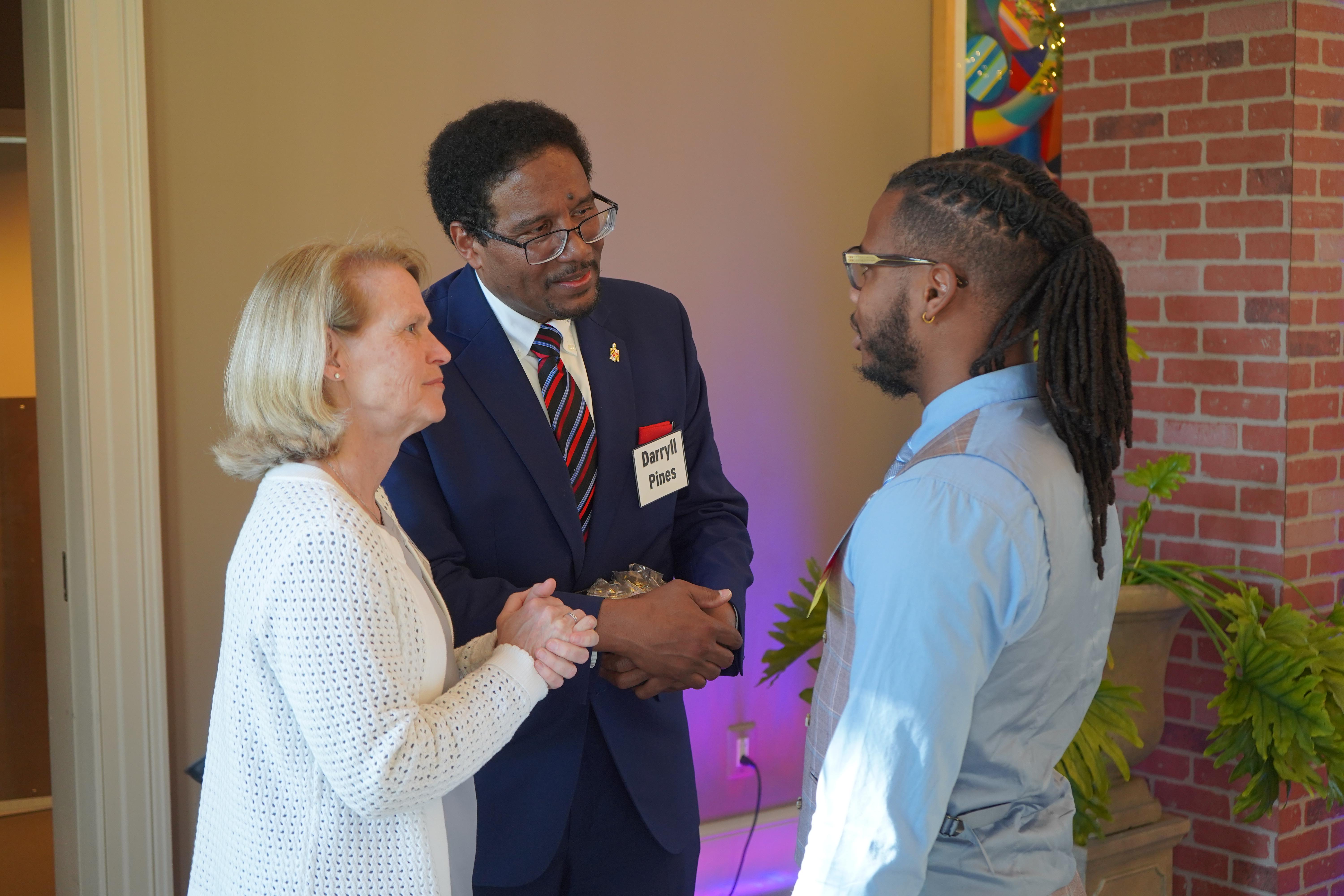 President Pines, Jennifer King Rice and a Doctoral Candidate at a celebration