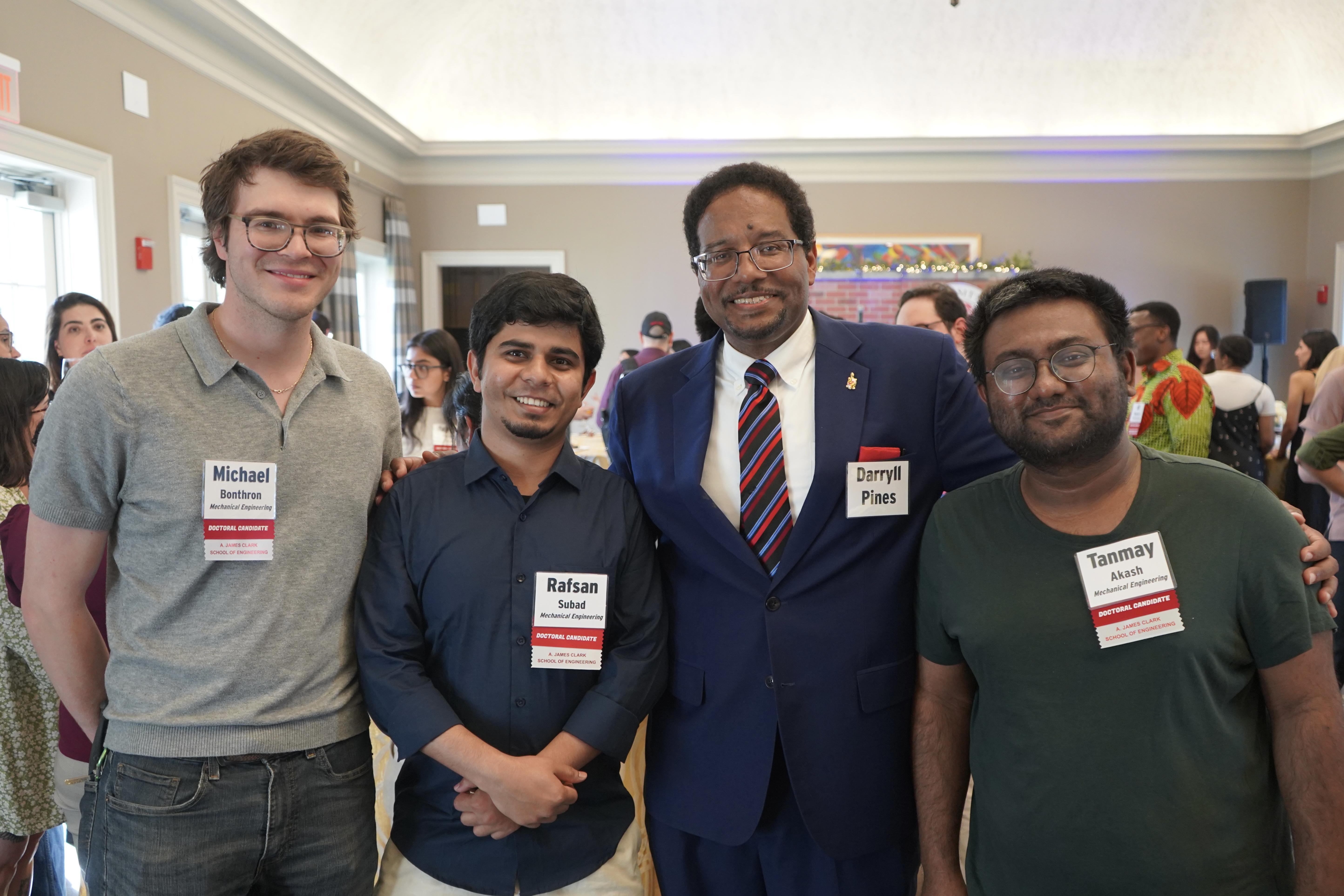 Three Doctoral Candidates at a celebration with President Pines