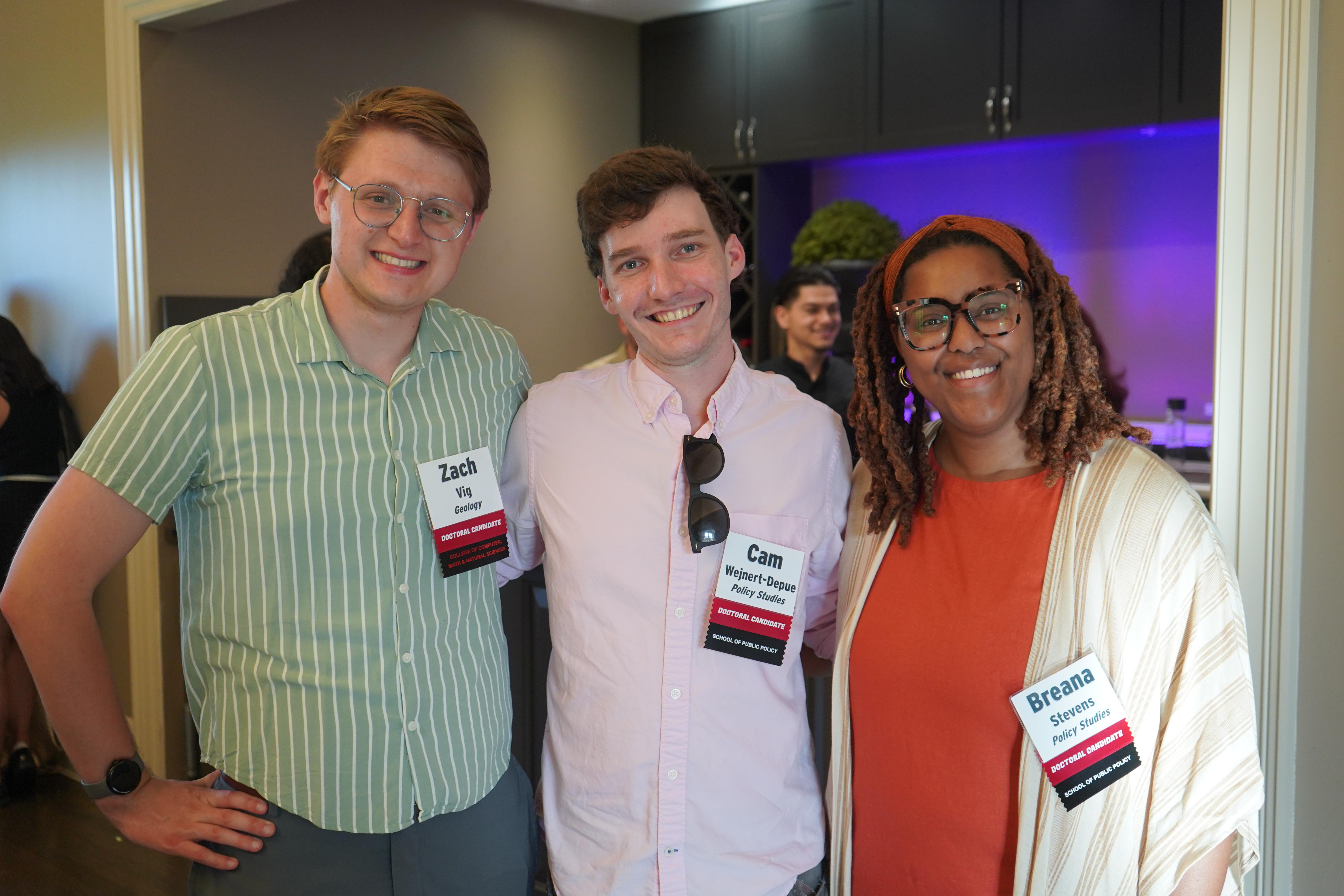 Three Doctoral Candidates at a celebration