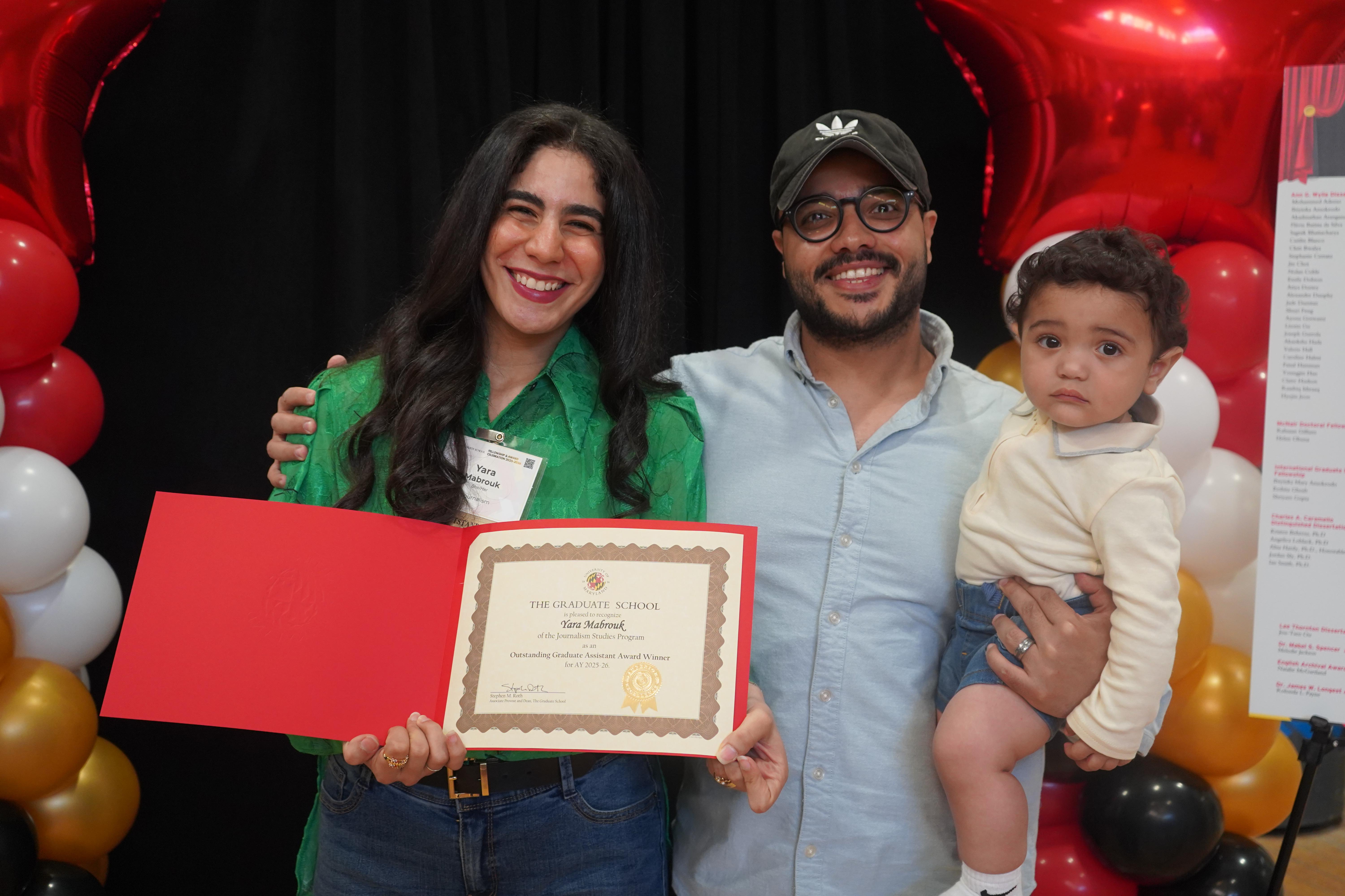 A graduate student and her family at the annual Fellowship and Award celebration