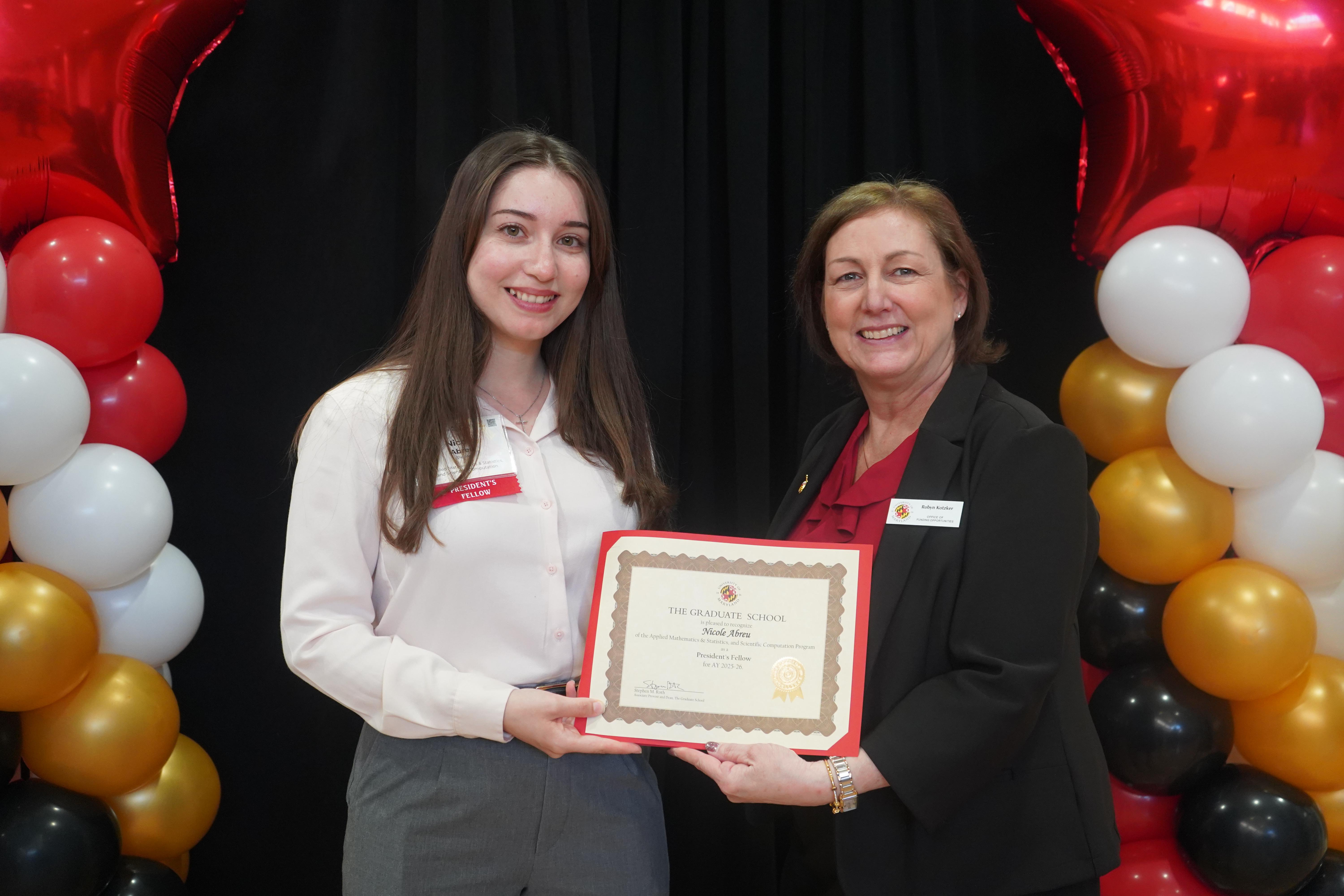A graduate student and Robyn Kotzker, Program Director of Funding Opportunities, smiling at the annual Fellowship and Award celebration