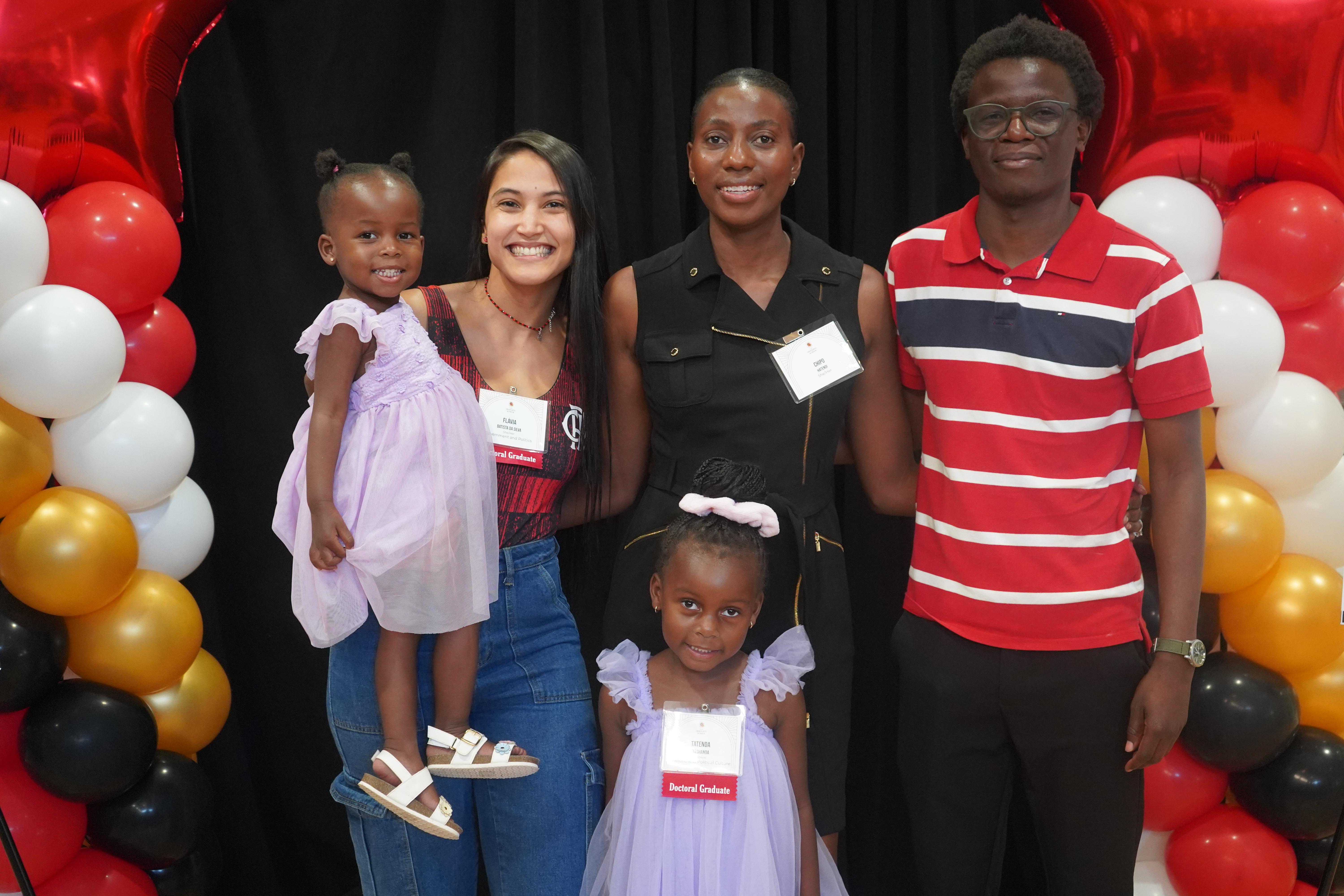 Group of Doctoral Graduate Students and family at a celebration